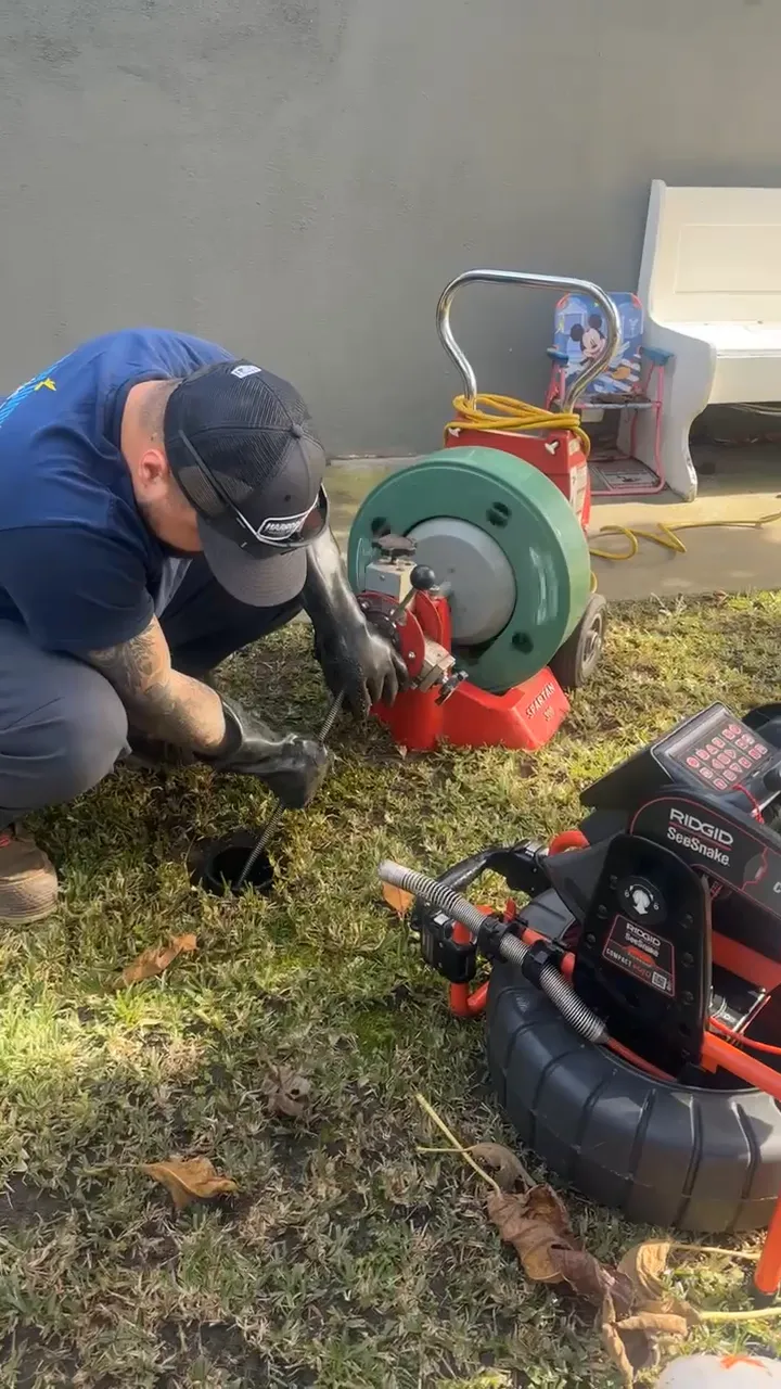 Flash Plumbing technician performing drain service