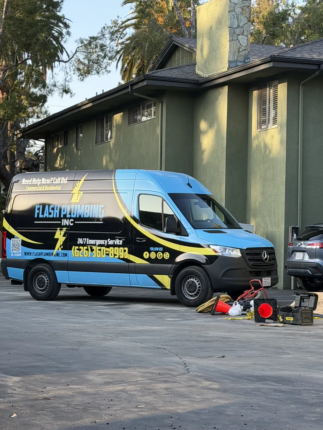 Flash Plumbing service van parked outside a local home