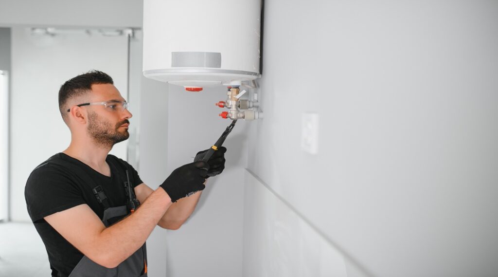 Professional plumber checking a boiler and pipes, boiler service concept